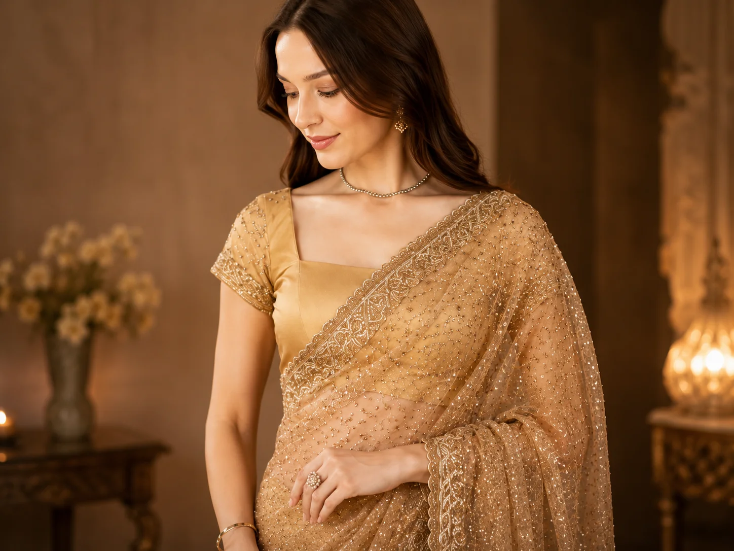 Close view of a golden embellished saree styled to highlight its ornate decorative border and drape.