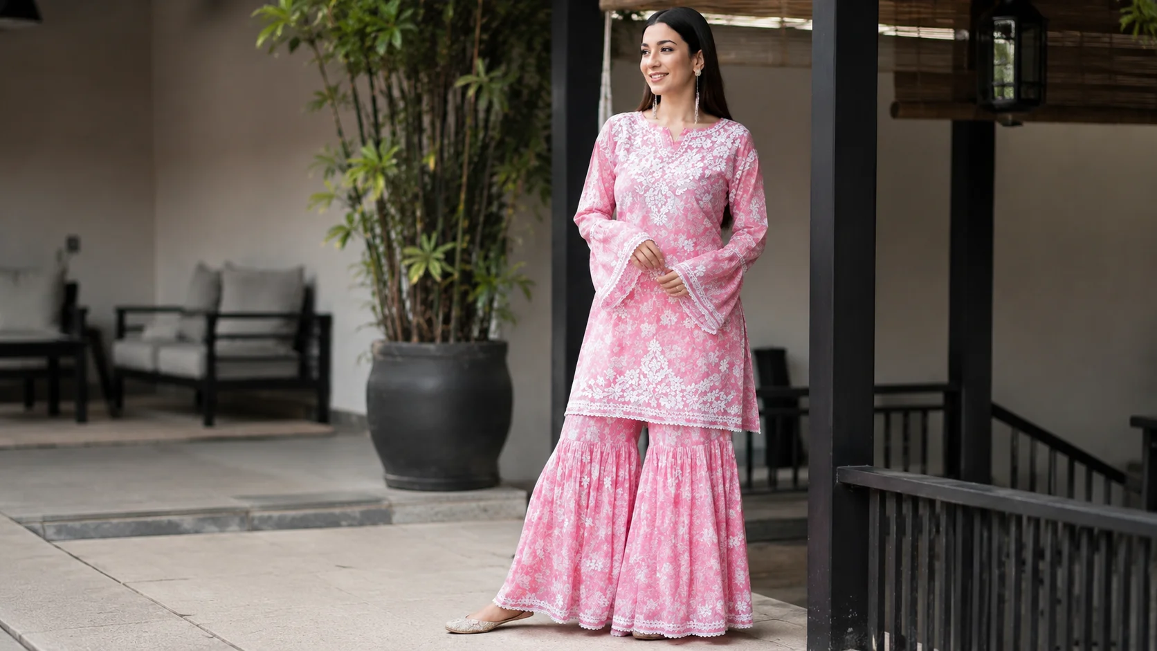 Woman wearing a pink embroidered kurta set with white floral detailing for elegant ethnic outfit styling inspiration