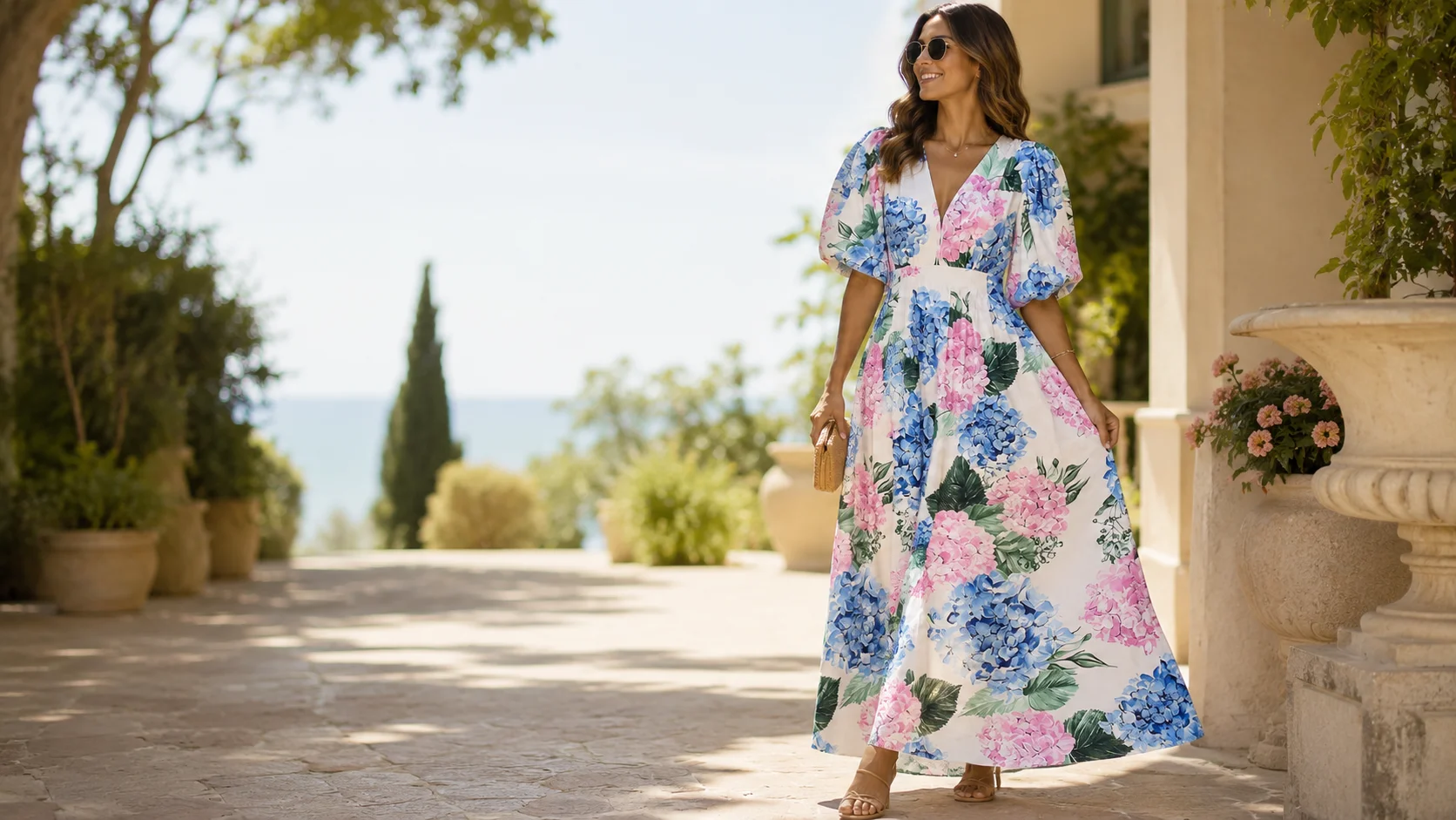 Woman wearing a pink and blue floral maxi dress styled for an elegant spring or summer occasion